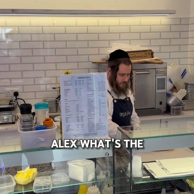 Behind MilkPod's glass counter — menu board and fresh kitchen